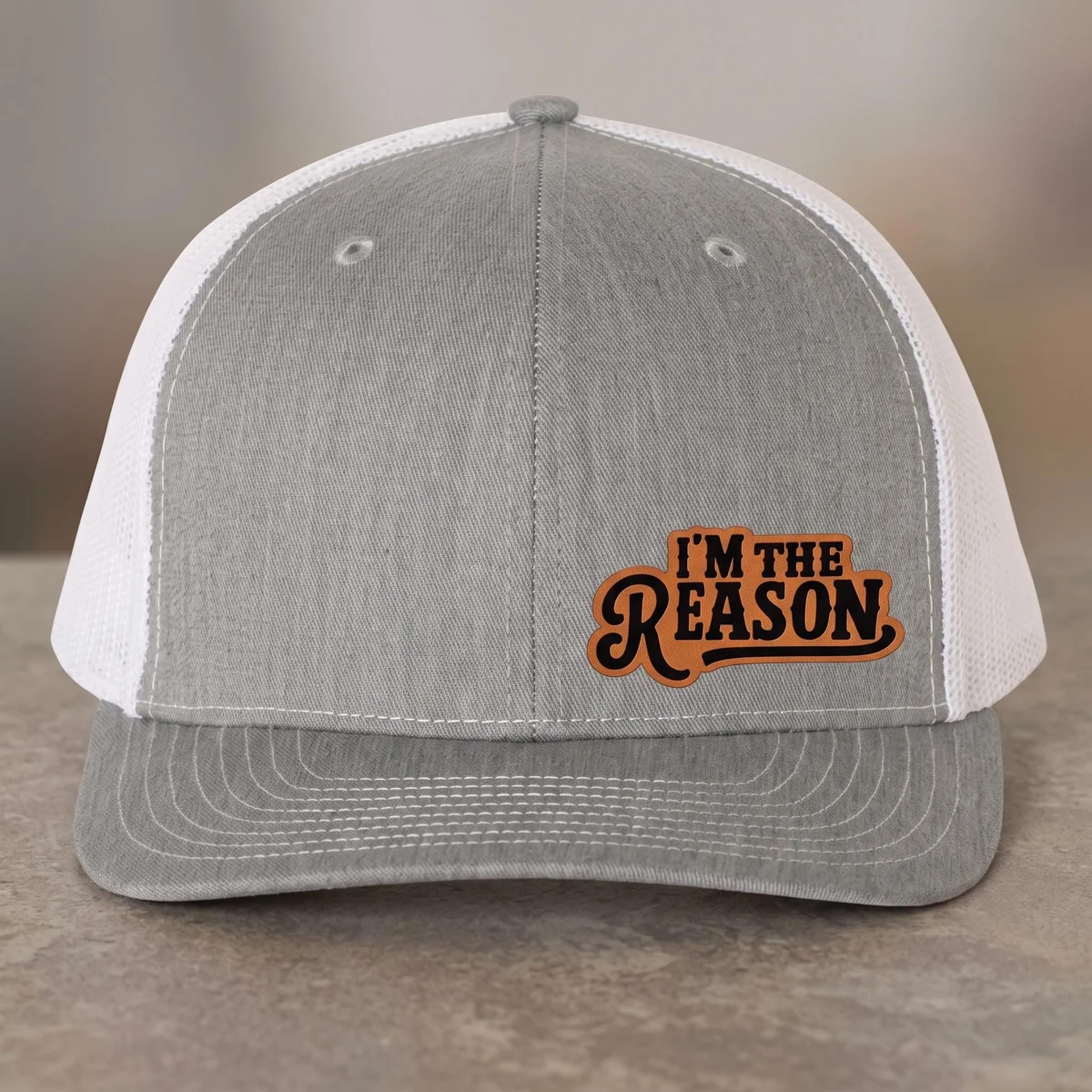 View 3 of I'm The Reason Leather Patch Trucker Hat